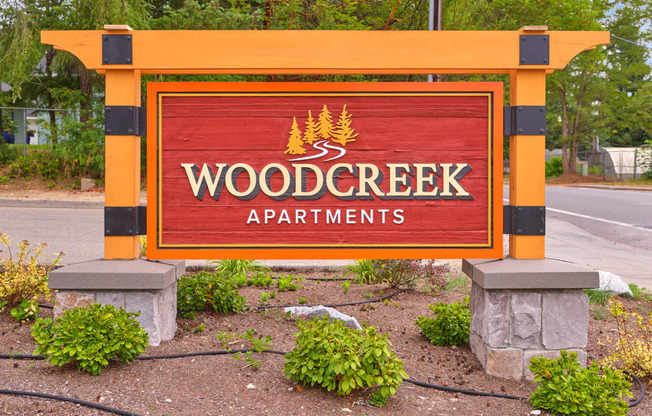 a sign for wood creek apartments on the side of the road at Woodcreek, Poulsbo, WA