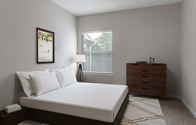 A bedroom with a bed, nightstand, and a poster on the wall.