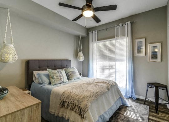 a bedroom with a bed and a ceiling fan