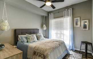 a bedroom with a bed and a ceiling fan
