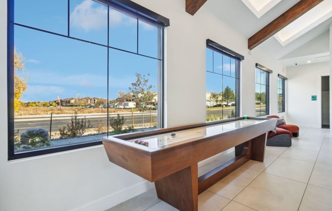 a pool table in a house with large windows