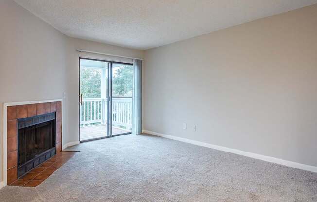 A room with a fireplace and sliding glass doors.