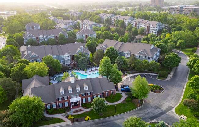 A bird's eye view of a residential area with houses and a swimming pool.