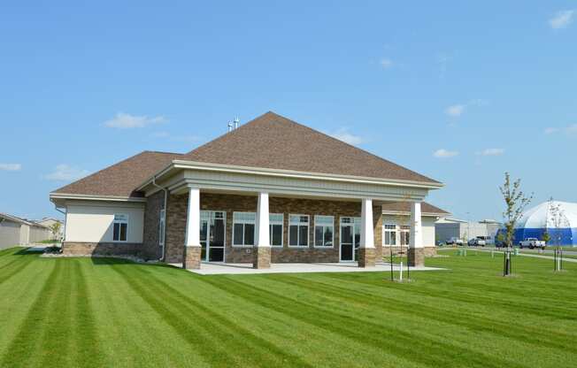 a building with a lawn in front of it. Fargo, ND Urban Plains Apartments