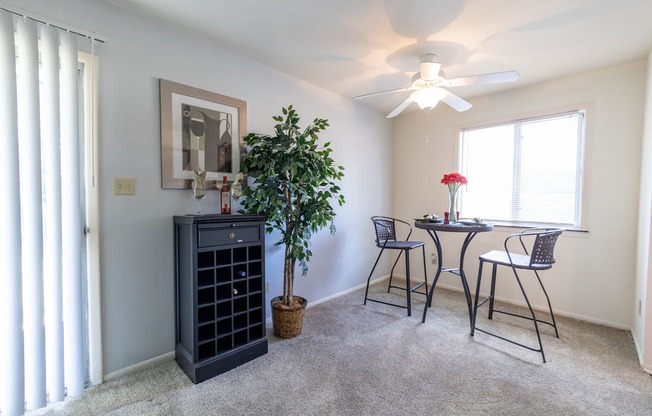 Dining room with a window and patio access at Woodbridge Apartments
