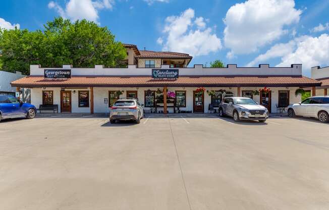 a parking lot in front of a restaurant with cars parked