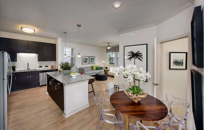 A modern kitchen with a dining table and chairs.