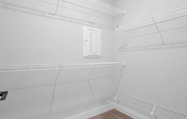 A white empty room with a door and a window.