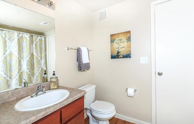 Bathroom with sink, toilet, and towel rackÂ 