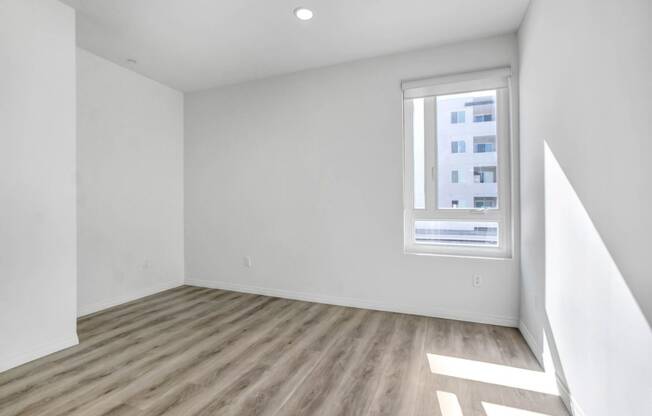 an empty room with white walls and a window