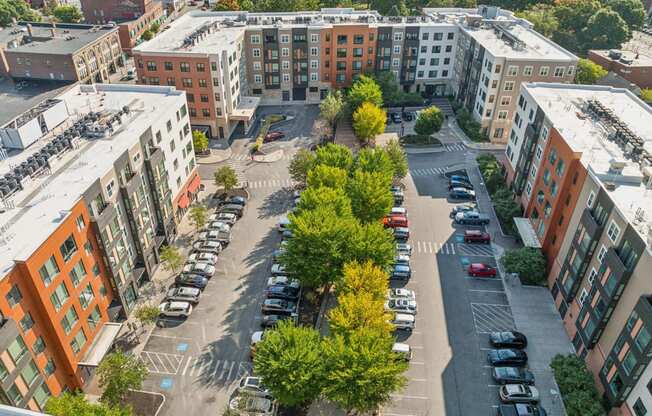 an aerial view of a city with cars parked in a parking lot at The Merc, Waltham, MA