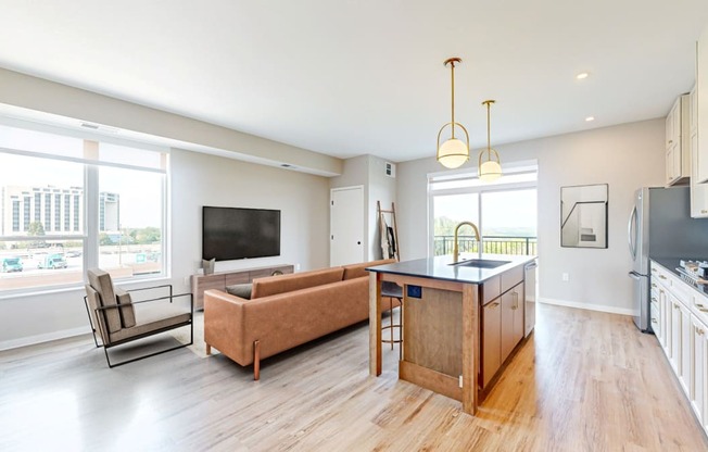 an open living room with a kitchen and a tv