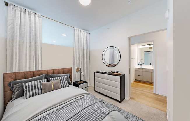 a bedroom with a large bed and a mirror