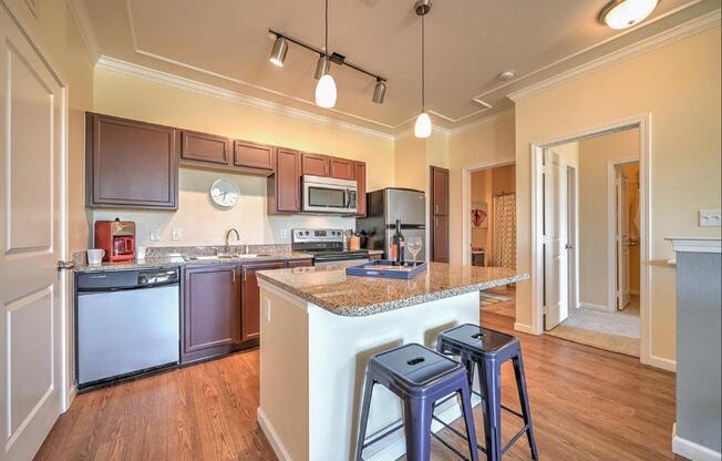 a kitchen with an island and bar stools