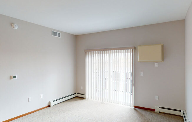 a living room with a large window and a sliding glass door