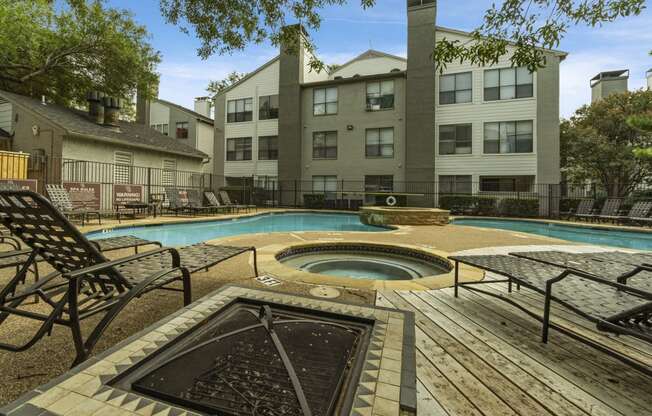 our apartments have a large swimming pool and a patio with chairs