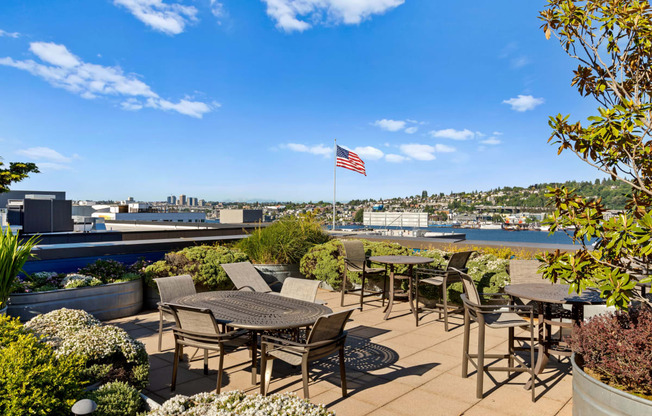 an outdoor patio with tables and chairs and an american flag at Dexter Lake Union, Seattle, WA