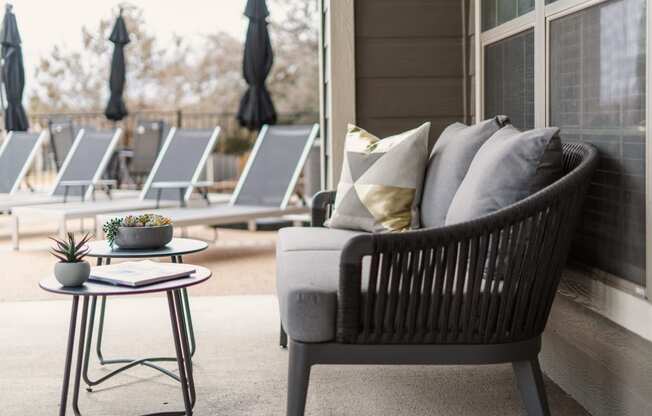 a patio chair with pillows on it