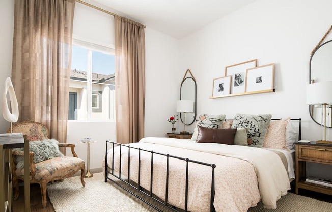 a bedroom with a bed and a chair and a window