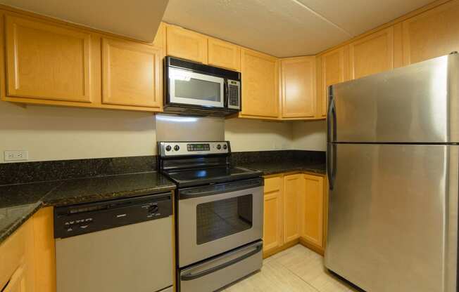 Napili Towers kitchen area with appliances, cabinets, and counters