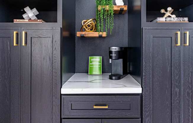 A kitchen with dark wood cabinets and a white countertop.