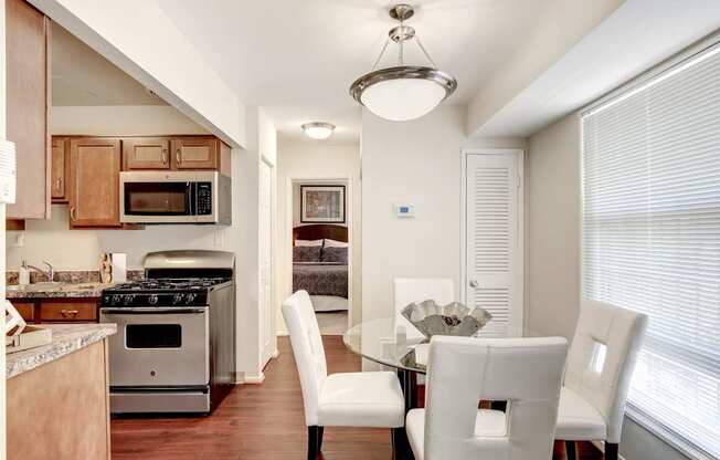 A modern kitchen with a dining table and chairs.