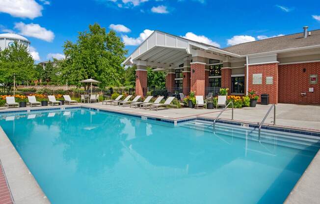 A large swimming pool with a building in the background.