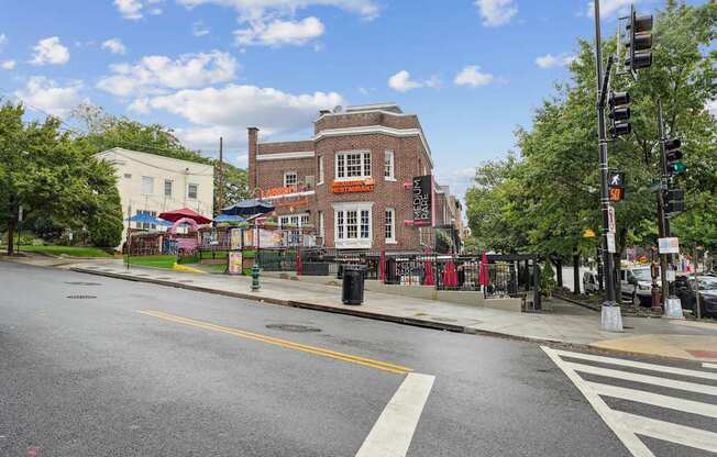 A city street with a crosswalk and traffic lights.