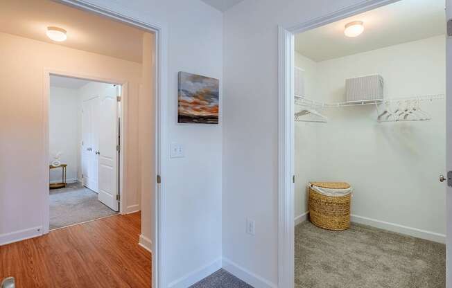 A room with a white door and a basket on the floor.