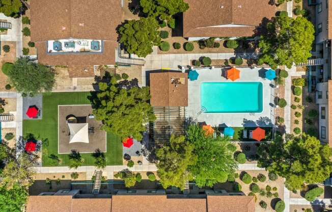 a birdseye view of a backyard with a pool and trees