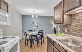 a kitchen and dining room with a table and chairs