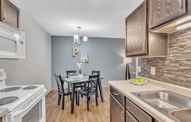 a kitchen and dining room with a table and chairs