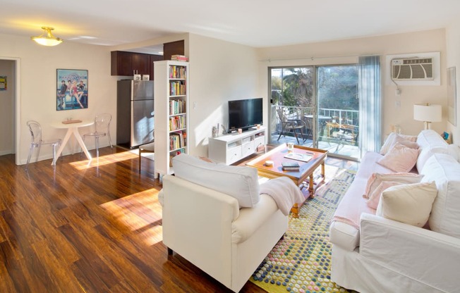 Apartment living room with private balcony and kitchen