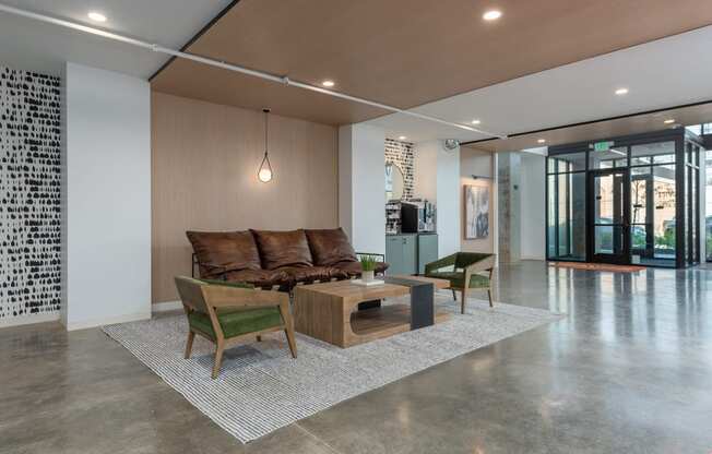 a living room with a couch and chairs and a coffee table