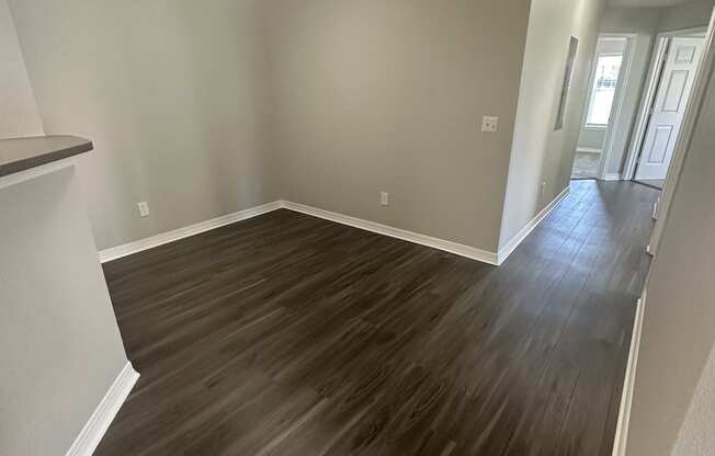 an empty room with a hardwood floor