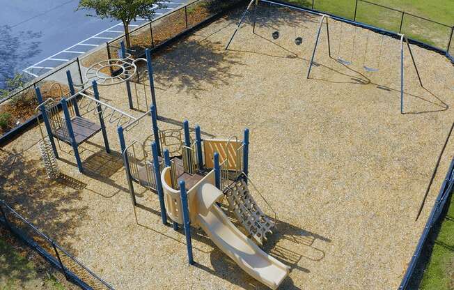 A playground with a slide, swings, and a climbing frame.