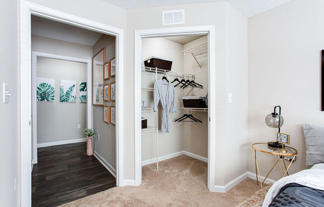 a bedroom with a closet and a bed and a mirror