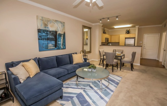 a living room with a blue couch and a coffee table