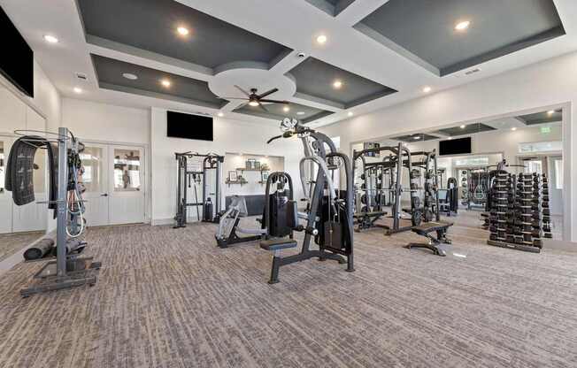 A spacious gym with a variety of equipment.