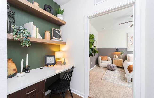 a living room with a desk and a mirror