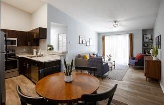 A modern kitchen with a dining table and chairs.