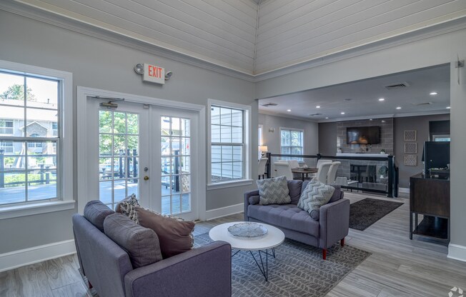 a living room with couches and a coffee table and a fireplace