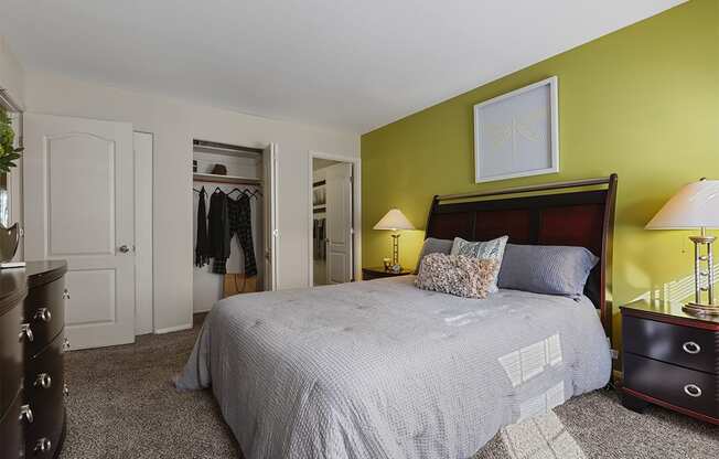 a bedroom with green walls and a large bed at Kenilworth at Charles, Towson MD
