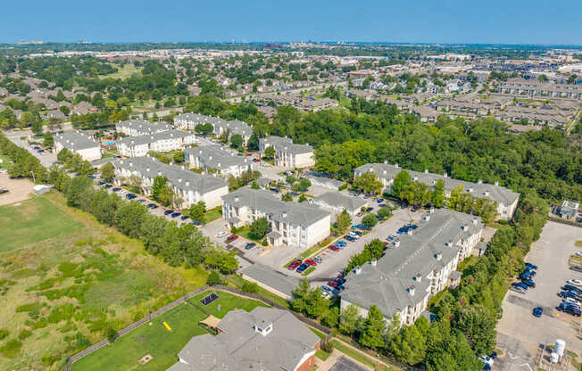 A bird's eye view of a residential area with houses and parked cars.