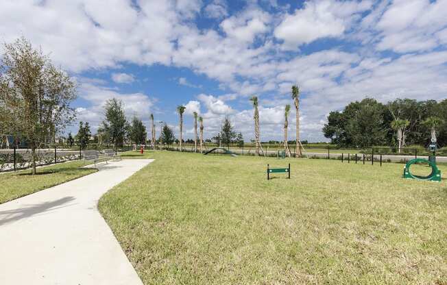 Fenced-in leash-Free Pet Park with agility course at Residences at The Green in Lakewood Ranch, FL