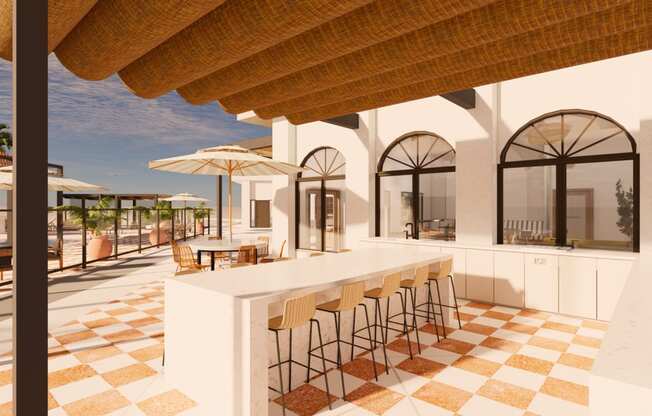 a bar area at a resort with chairs and umbrellas