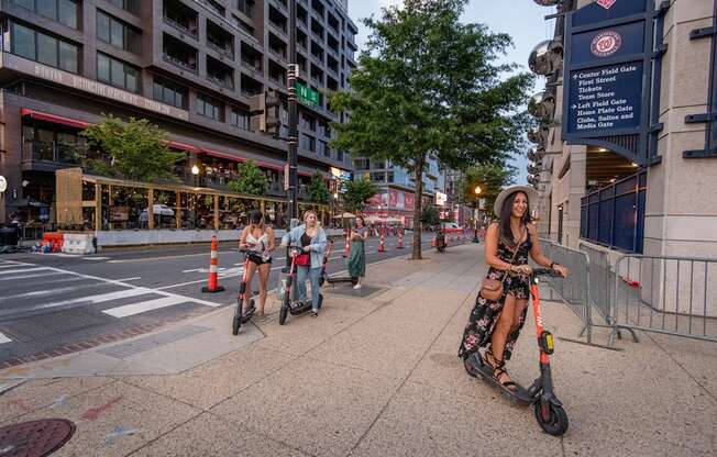 A woman riding an electric scooter on a city street.