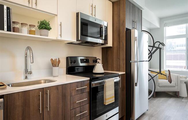 a kitchen with a sink and a refrigerator and a microwave