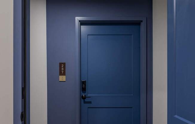 A blue door with a sign on it.