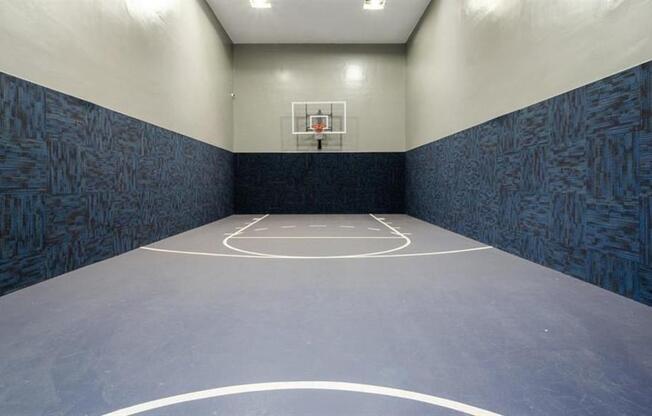a basketball court in an empty gym